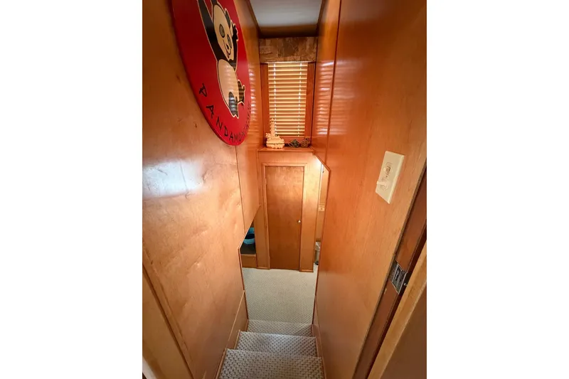 Slide: The Image of Narrow wooden hallway with stairs, featuring a panda-themed wall decoration. - 23