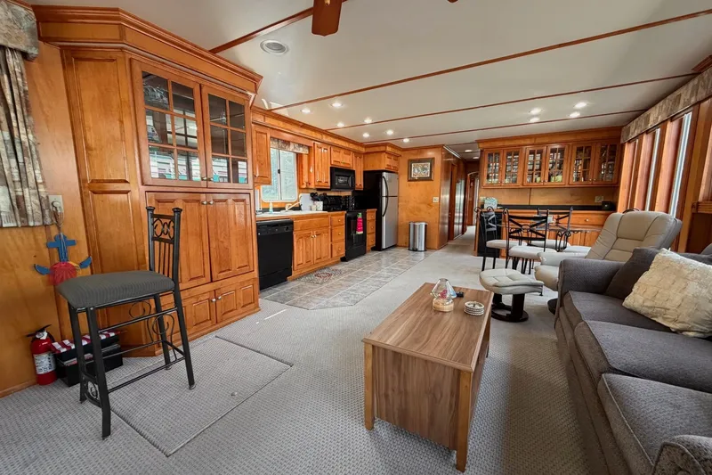 Slide: The Image of Spacious Lakeview houseboat interior with wooden cabinetry, cozy seating, and modern kitchen amenities. - 11