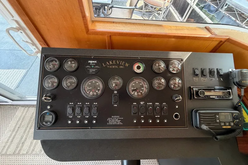 Slide: The Image of Control panel of a Lakeview yacht with gauges, switches, and communication equipment. - 13