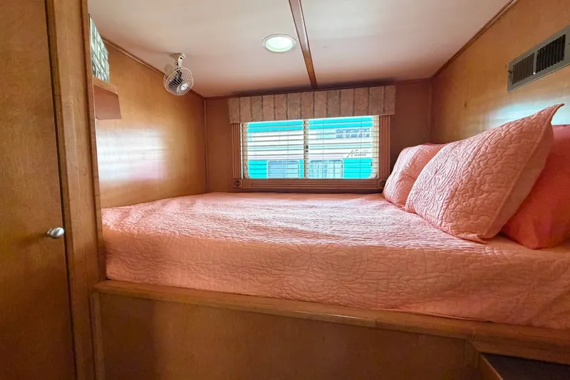 Slide: The Image of Cozy Lakeview cabin bedroom with pink bedding, wooden walls, and a window view. - 21