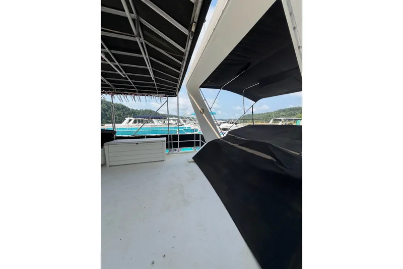 Slide: The Image of Upper deck of a Lakeview boat with canopy, overlooking marina and distant hills. - 42