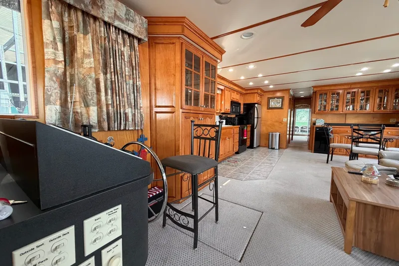 Slide: The Image of Spacious Lakeview houseboat interior with wooden cabinetry, modern kitchen, and cozy seating area. - 7
