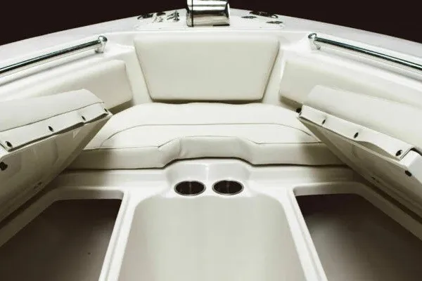 Slide: The Image of 2027 Key West 239 FS boat interior with cushioned seating and cup holders. - 15