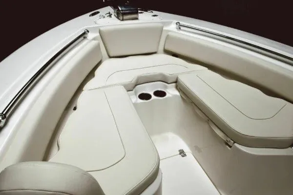 Slide: The Image of 2027 Key West 239 FS boat interior with cushioned seating and cup holders. - 14