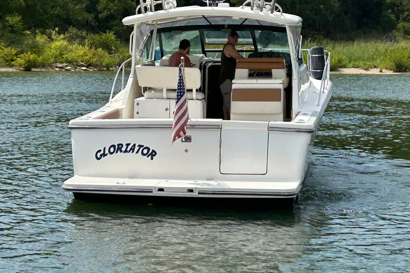 Slide: The Image of 2002 Tiara Yachts 3500 Open boat on water, rear view with American flag. - 49