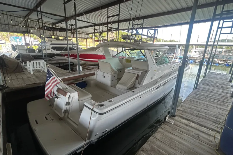 Slide: The Image of 2002 Tiara Yachts 3500 Open docked in a marina, featuring sleek design and American flag. - 16