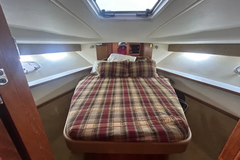 Slide: The Image of Cozy cabin interior of 2002 Tiara Yachts 3500 Open with plaid bedding. - 31