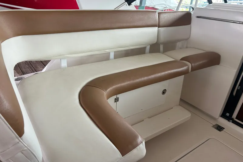 Slide: The Image of 2002 Tiara Yachts 3500 Open interior seating with brown and white upholstery. - 25