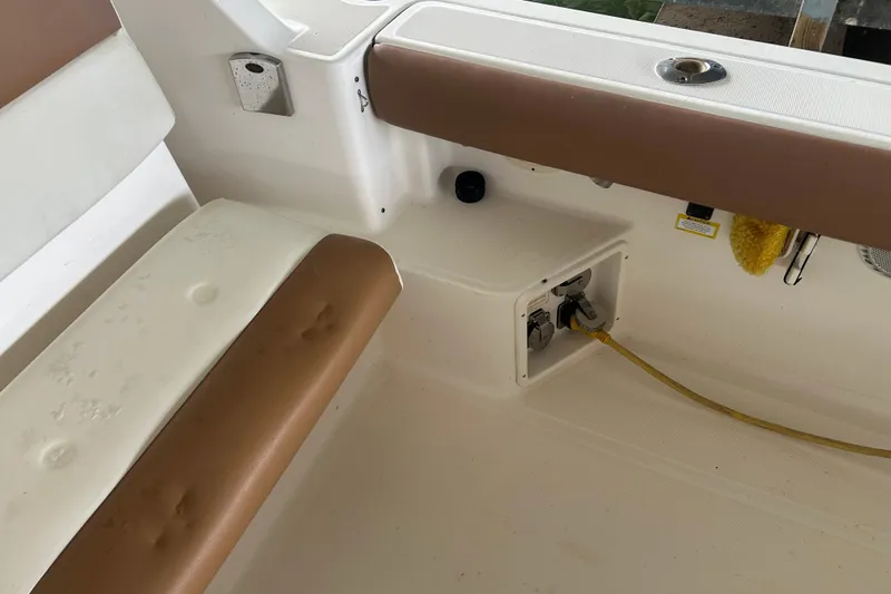 Slide: The Image of Interior view of a 2002 Tiara Yachts 3500 Open, featuring seating and utility connections. - 24