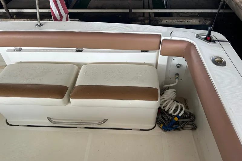 Slide: The Image of Tiara Yachts 3500 Open 2002 boat seating area with storage and coiled ropes. - 22