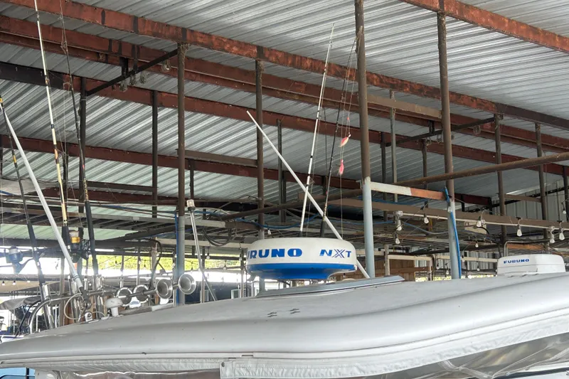 Slide: The Image of Tiara Yachts 3500 Open 2002 under metal roof with fishing gear and radar equipment. - 15
