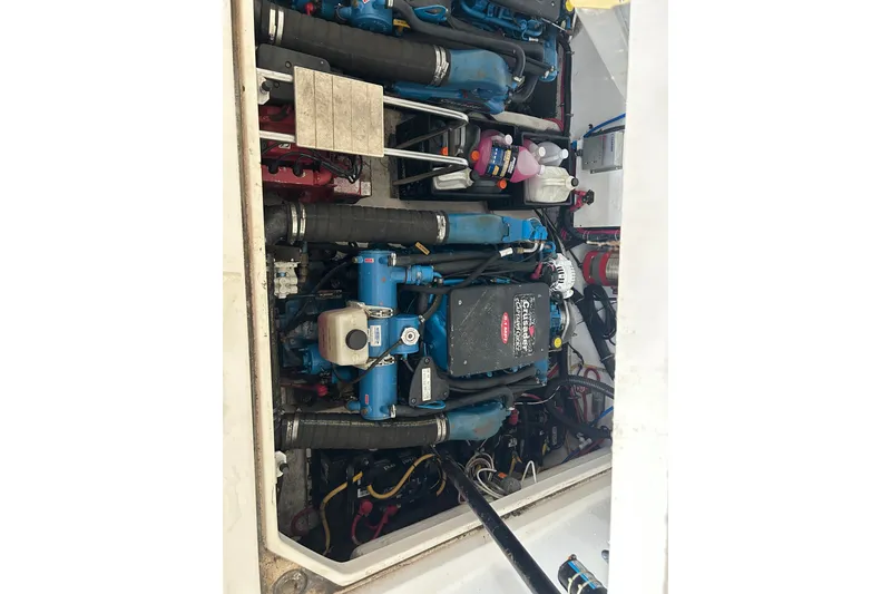 Slide: The Image of Engine compartment of a 2002 Tiara Yachts 3500 Open, showcasing mechanical components and hoses. - 40