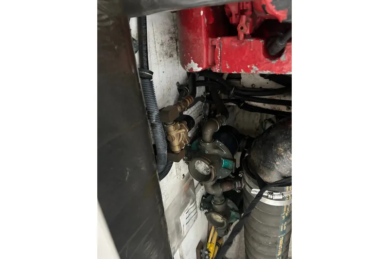 Slide: The Image of Engine compartment of a 2002 Tiara Yachts 3500 Open, showing mechanical components and hoses. - 42