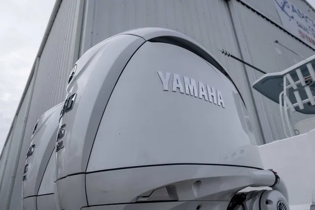 Slide: The Image of Close-up of a white Yamaha outboard motor on a boat, in front of a large building. - 28