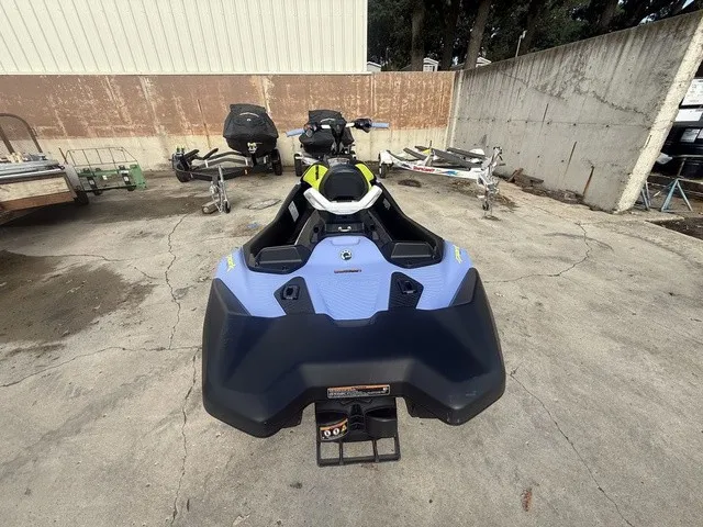 Slide: The Image of A 2024 Sea-Doo Spark Trixx for 3 is on a concrete surface. It features a modern design with blue and black accents. - 6