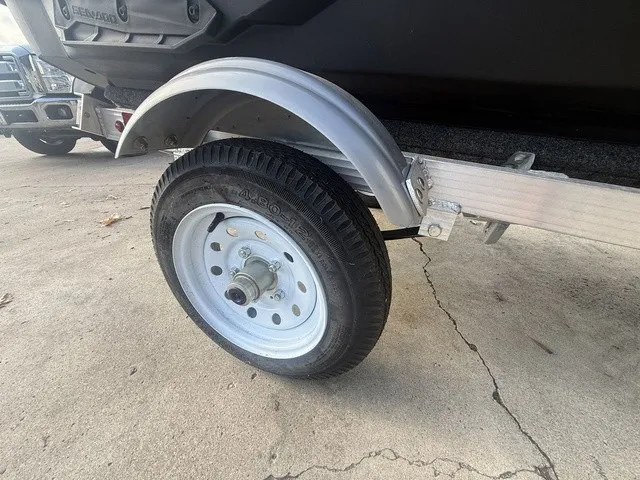 Slide: The Image of Close-up of a boat trailer with a sturdy tire and metal fender. - 13