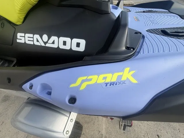 Slide: The Image of Close-up of a Sea-Doo Spark Trixx jet ski with blue and black design. - 11