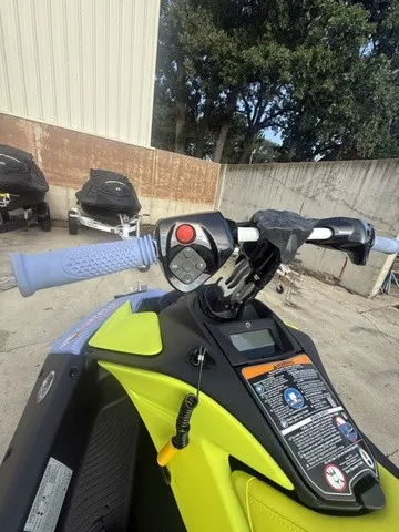 Slide: The Image of Close-up of the handlebars on a 2024 Sea-Doo Spark Trixx for 3, featuring blue grips. - 10