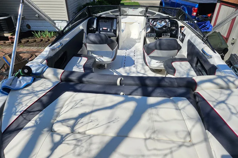 Slide: The Image of 2013 Larson LSR 2300 I/O boat interior with seating and steering wheel. - 17
