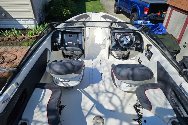Slide: The Image of Interior of a 2013 Larson LSR 2300 I/O boat with seating and steering wheel. - 16