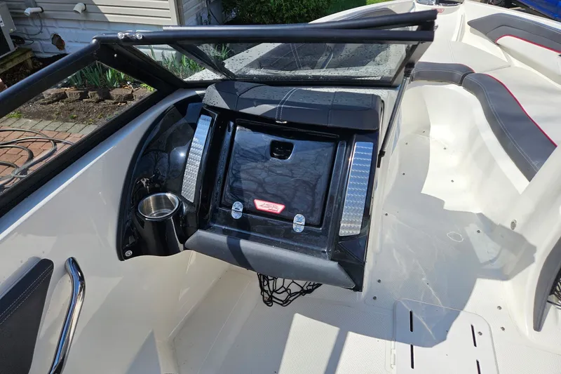 Slide: The Image of 2013 Larson LSR 2300 I/O boat interior with seating and dashboard view. - 15