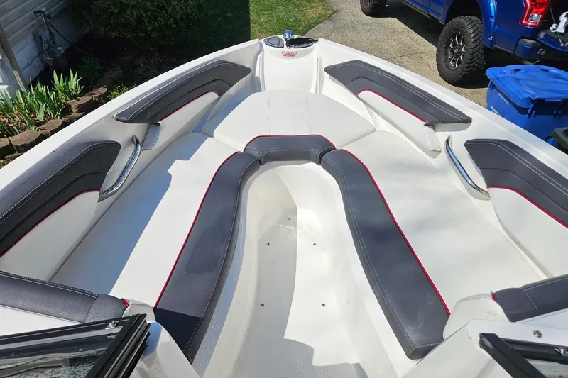 Slide: The Image of Interior view of a 2013 Larson LSR 2300 I/O boat with white and gray seating. - 14