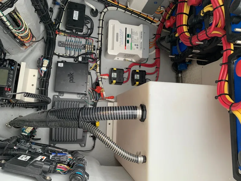 Slide: The Image of The image shows a boat's engine room with various electrical components and wiring. - 19