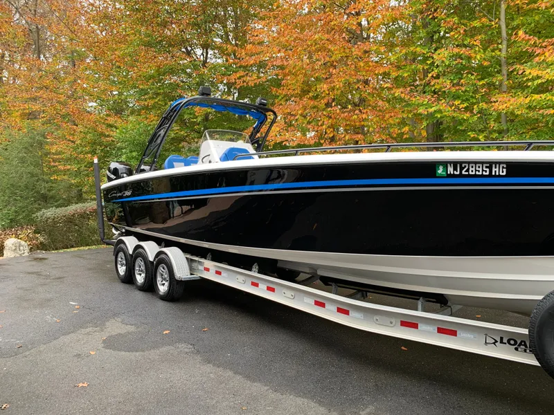 Slide: The Image of A black 36-foot boat on a trailer, surrounded by autumn trees. - 15
