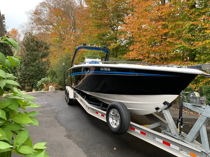 Slide: The Image of A black boat on a trailer, surrounded by autumn trees. - 22