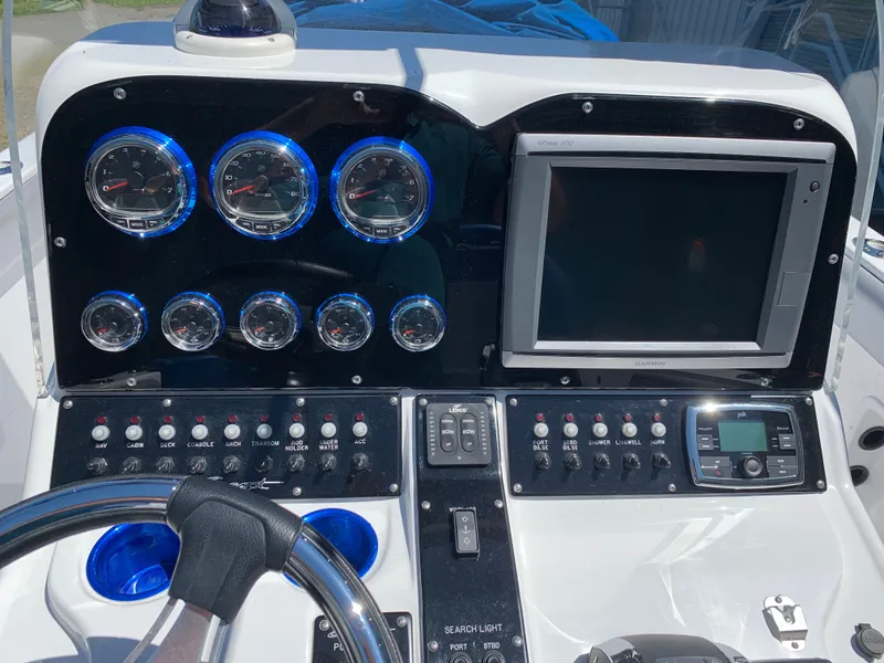 Slide: The Image of The image shows a boat dashboard with multiple gauges and a large screen. - 16