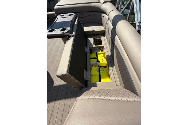 Slide: The Image of 2022 Bennington L 25 FISHING SSAPG boat interior with open storage compartment and cup holders. - 14