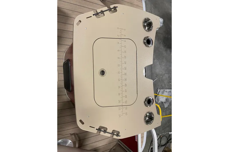 Slide: The Image of 2022 Bennington L 25 FISHING SSAPG boat console with cup holders and measurement markings. - 12