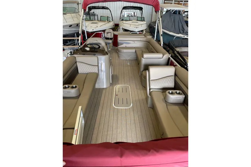 Slide: The Image of 2022 Bennington L 25 FISHING SSAPG pontoon boat interior with beige seating and red canopy. - 9