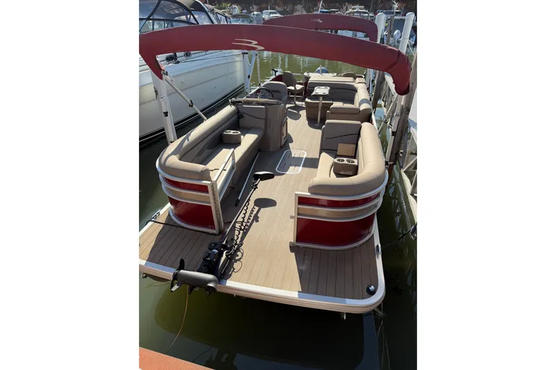 Slide: The Image of 2022 Bennington L 25 FISHING SSAPG pontoon boat with red canopy and beige seating. - 1