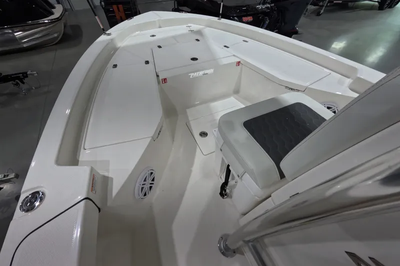 Slide: The Image of Interior view of a 2027 Pathfinder 2200 Hybrid boat, showcasing seating and storage areas. - 16