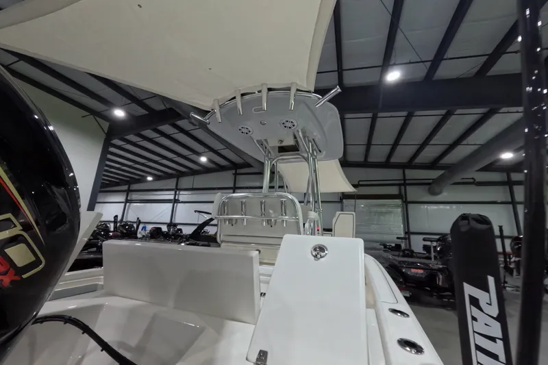 Slide: The Image of 2027 Pathfinder 2200 Hybrid boat in a showroom, showcasing sleek design and modern features. - 25