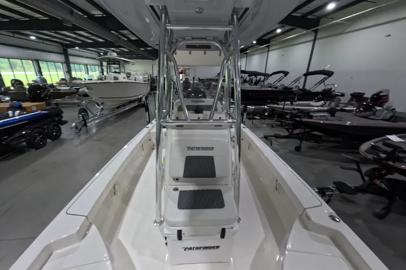 Slide: The Image of 2027 Pathfinder 2200 Hybrid boat displayed in a showroom with other boats. - 17