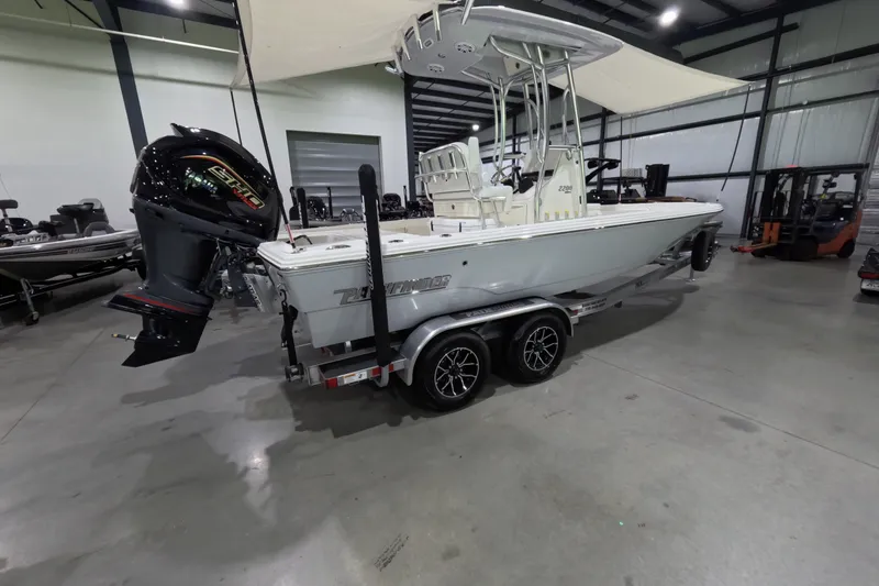 The Image of 2027 Pathfinder 2200 Hybrid boat in showroom, featuring sleek design and powerful engine. - 1