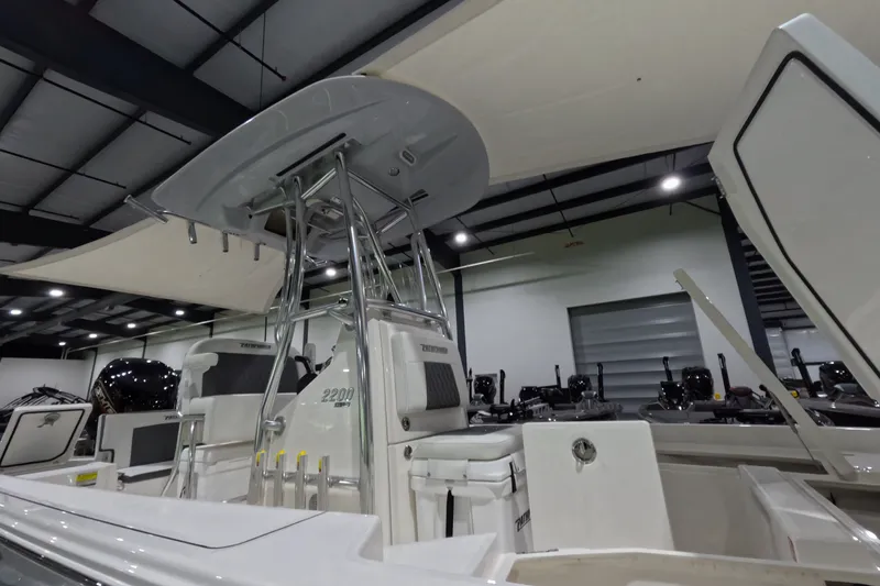 Slide: The Image of 2027 Pathfinder 2200 Hybrid boat interior with T-top and seating in showroom. - 26