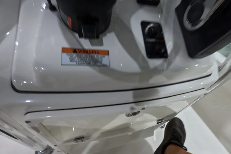 Slide: The Image of Close-up of 2027 Pathfinder 2200 Hybrid boat dashboard with warning label and controls. - 14
