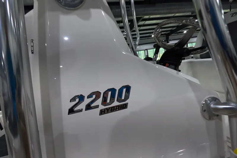 Slide: The Image of Pathfinder 2200 Hybrid 2027 boat interior with steering wheel and model emblem. - 21