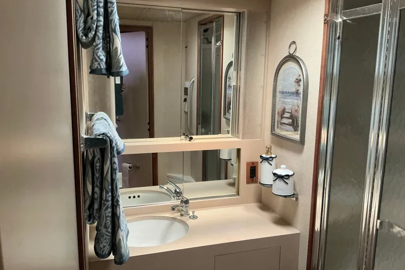 Slide: The Image of Bathroom interior of 1985 Bertram 42 Convertible yacht with mirror and decorative elements. - 13