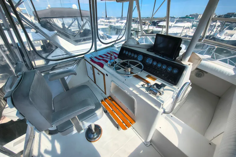 Slide: The Image of Cockpit of 1985 Bertram 42 Convertible yacht with steering wheel and navigation equipment. - 6