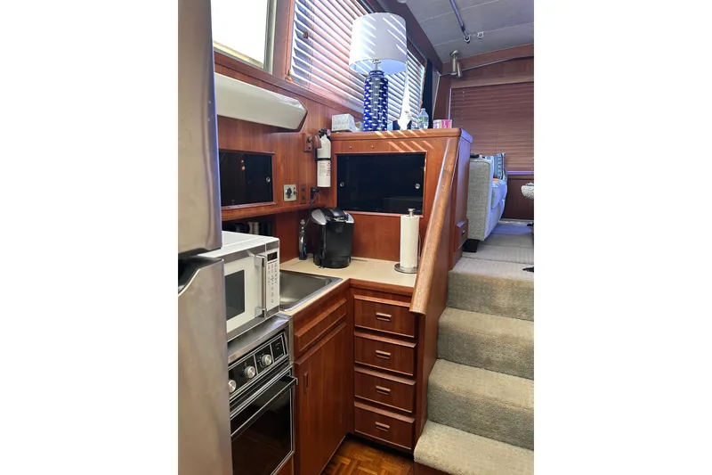 Slide: The Image of Interior of 1985 Bertram 42 Convertible yacht with kitchen and stairs. - 10