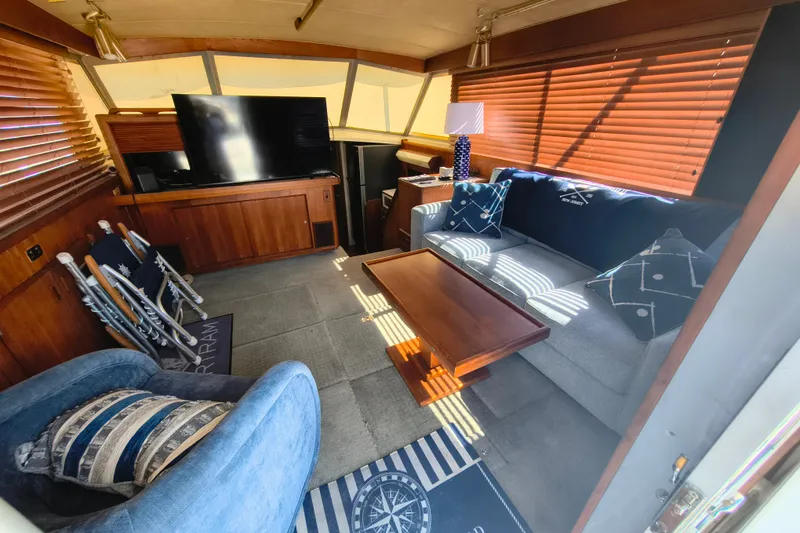 Slide: The Image of Interior of 1985 Bertram 42 Convertible yacht with cozy seating and modern decor. - 13