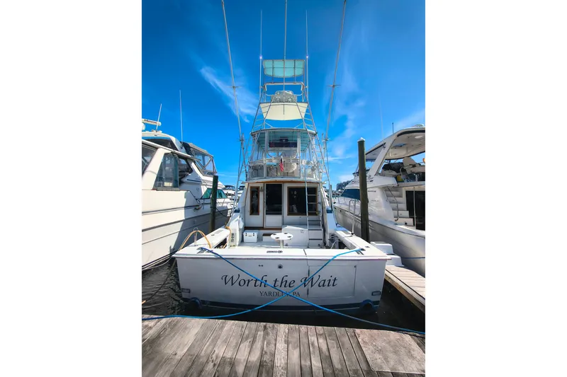Slide: The Image of 1985 Bertram 42 Convertible yacht docked, rear view, clear blue sky. - 3
