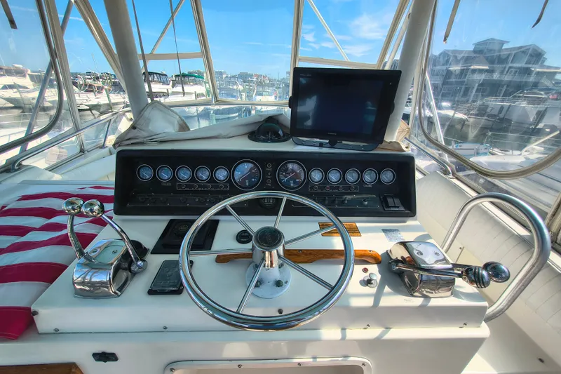 Slide: The Image of Cockpit of a 1985 Bertram 42 Convertible yacht with steering wheel and controls. - 7