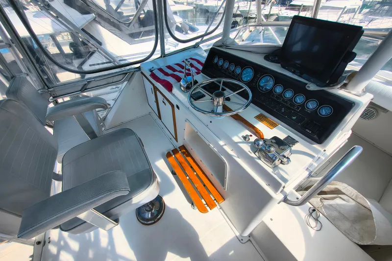 Slide: The Image of Cockpit of 1985 Bertram 42 Convertible with steering wheel and navigation instruments. - 4