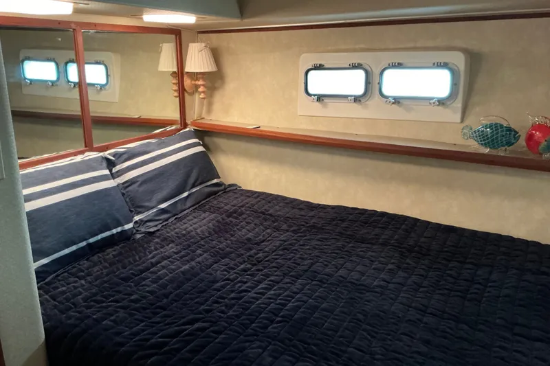 Slide: The Image of Cozy bedroom in 1985 Bertram 42 Convertible yacht with nautical decor. - 12