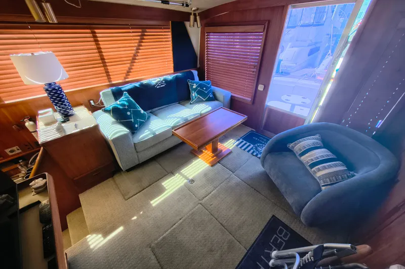 Slide: The Image of Interior of 1985 Bertram 42 Convertible yacht with cozy seating and wooden accents. - 14